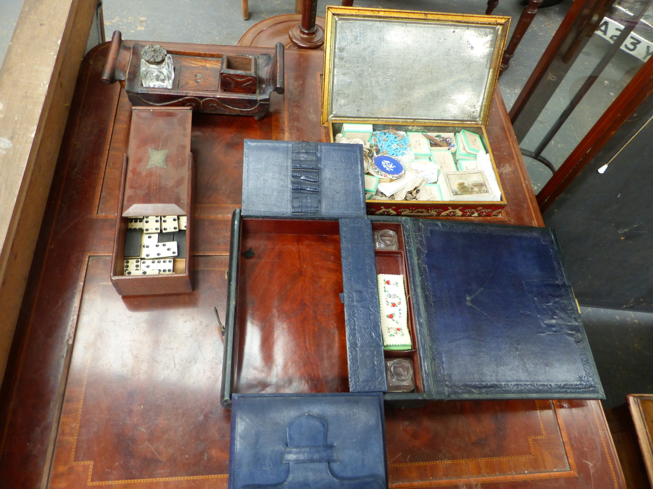 A 19th.C. MAHOGANY SLIDE TOP BOX CONTAINING DOMINOES, A RUSTIC OAK DESK STAND, A LEATHER BOUND