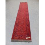 AN AFGHAN BELOUCH RUNNER. 373 x 82cms.