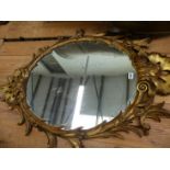 A CARVED GILTWOOD OVAL WALL MIRROR IN THE GEORGIAN TASTE.