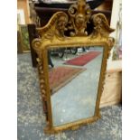 AN 18th.C. STYLE RECTANGULAR MIRROR THE GILT FRAME WITH FOLIAGE CENTRED BROKEN ARCH PEDIMENT,