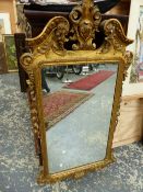 AN 18th.C. STYLE RECTANGULAR MIRROR THE GILT FRAME WITH FOLIAGE CENTRED BROKEN ARCH PEDIMENT,