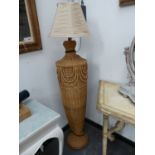 A BASKET WORK STANDARD LAMP, THE SHOULDERED OVOID BODY ON FLARED FOOT. H 107cms.