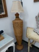 A BASKET WORK STANDARD LAMP, THE SHOULDERED OVOID BODY ON FLARED FOOT. H 107cms.