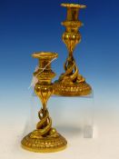 A PAIR OF ORMOLU CANDLESTICKS, THE GADROONED NOZZLES RAISED ON TULIP TOPPED COLUMNS, THE SLENDER