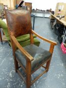 A LEATHER UPHOLSTERED WALNUT ELBOW CHAIR, THE SQUARE LEGS JOINED BY STRETCHERS.