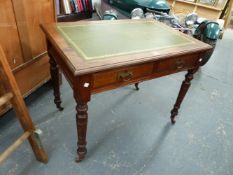 A LATE VICTORIAN WALNUT TWO DRAWER WRITING TABLE WITH INSET GREEN LEATHER TOP. H. 70 x W. 92 x D.