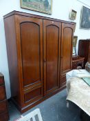 A HOWARD AND SONS VICTORIAN FRUITWOOD TRIPLE COMPACTUM WARDROBE, EBONISED MOULDINGS. H 196 x W