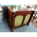 A VICTORIAN MAHOGANY TWO DOOR CABINET, COLUMN PILASTERS FLANK GRILLED DOORS. SHAPED PLINTH BASE.