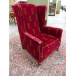 AN EDWARDIAN WING BACK ARMCHAIR WITH PERIOD VELOUR UPHOLSTERY ON SHORT SQUARE TAPERED LEGS AND