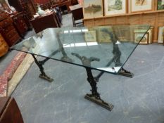 A PAIR OF VICTORIAN CAST IRON TRESTLE STANDS SUPPORTING A LARGE PLATE GLASS DINING TABLE TOP. H.