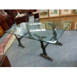 A PAIR OF VICTORIAN CAST IRON TRESTLE STANDS SUPPORTING A LARGE PLATE GLASS DINING TABLE TOP. H.