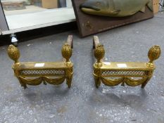 A PAIR OF ORMOLU FIRE DOGS EACH WITH SWAGGED FRONTS BEARING TWO FRUITING CONES AND WITH IRON BARS AT
