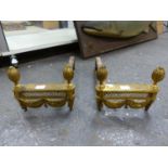 A PAIR OF ORMOLU FIRE DOGS EACH WITH SWAGGED FRONTS BEARING TWO FRUITING CONES AND WITH IRON BARS AT