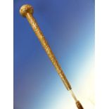 AN INDIAN WHITE METAL HANDLED SWORD STICK, THE CANE SCABBARD HOUSING A BLADE OF SQUARE SECTION.