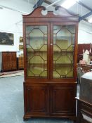 A GEORGIAN CARVED MAHOGANY BOOKCASE CABINET, SCROLL BROKEN PEDIMENT ABOVE GLAZED DOORS, PANELLED