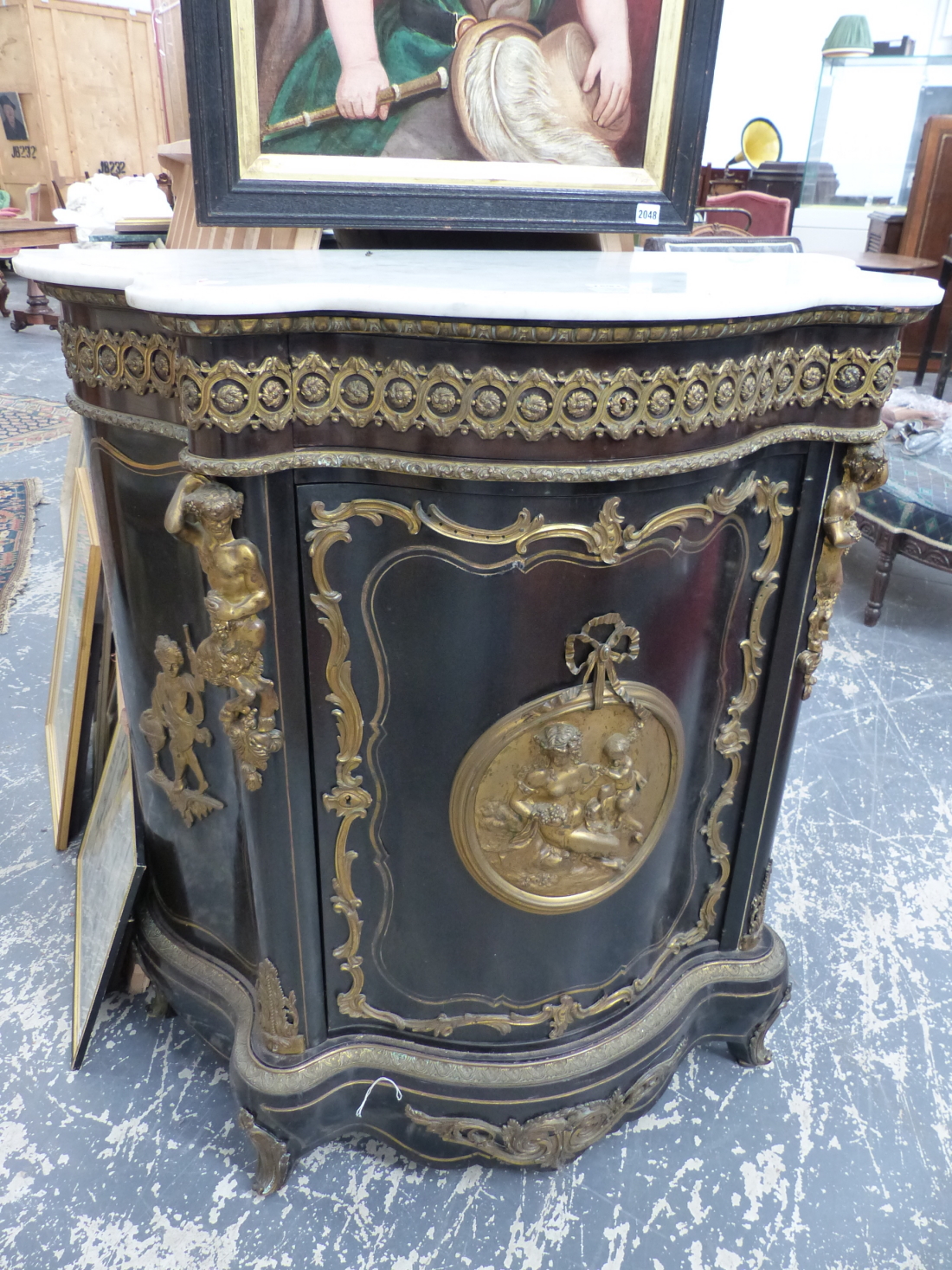 A FRENCH 19th.C.EBONISED ORMOLU MOUNTED MARBLE TOP CABINET, SERPENTINE FORM WITH FIGURAL MOUNTS
