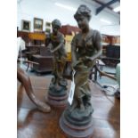 A PAIR OF BRONZED SPELTER FIGURES AFTER AUGUSTE MOREAU, THE LADIES HOLDING SONG BIRDS, RED MARBLED
