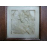 AN OAK FRAMED WHITE MARBLE RELIEF PANEL CARVED WITH A MOTHER KNEELING TO RUB HEADS WITH HER BABY