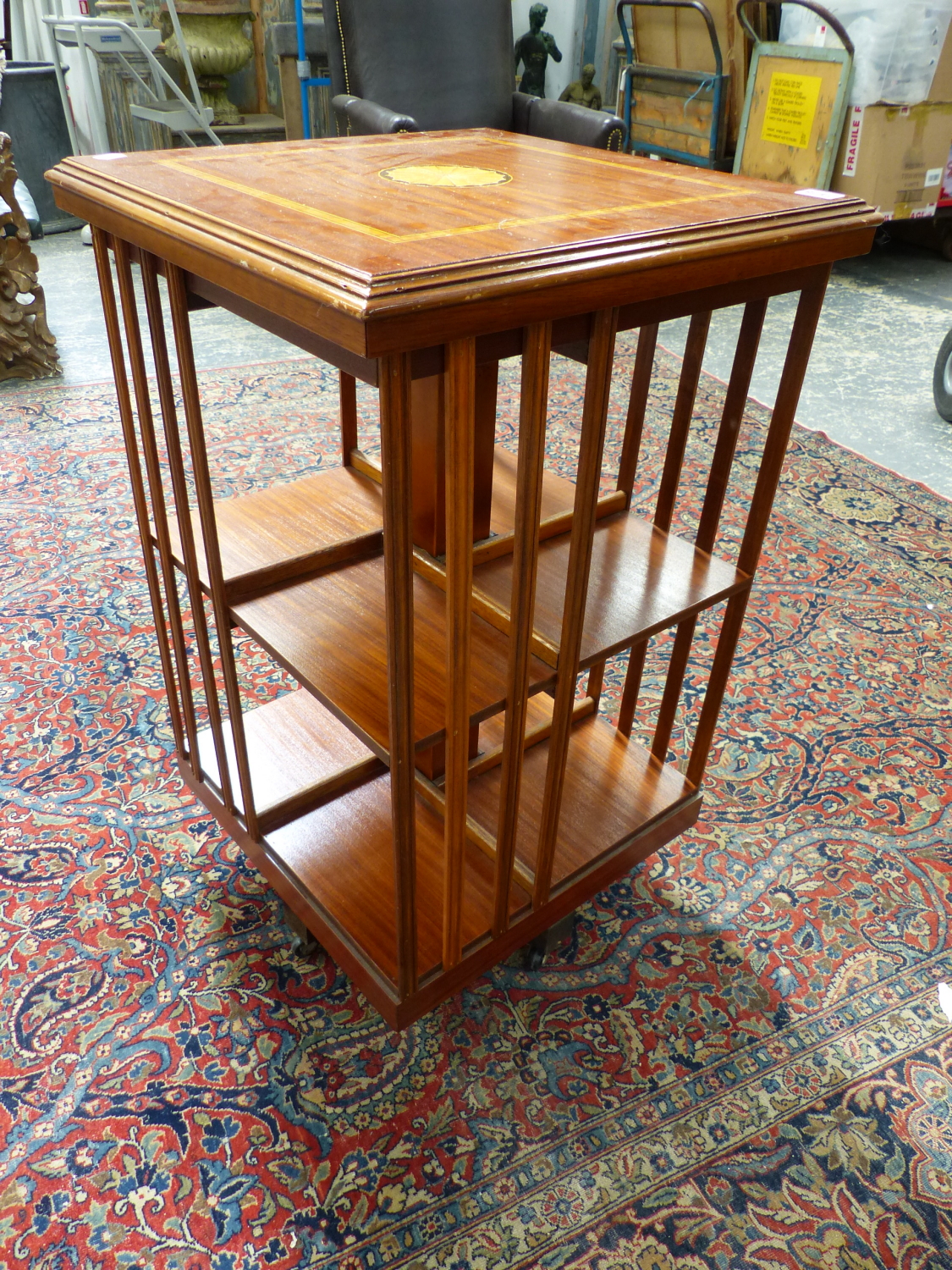 AN EDWARDIAN STYLE MAHOGANY AND INLAID SMALL REVOLVING BOOKCASE. 48 x 48 x H.79cms.