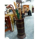 A MAHOGANY AND BRASS BOUND STICK STAND AND A QUANTITY OF WALKING STICKS, ETC.