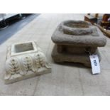 A CARVED STONE STAND OR MORTAR, COLUMNS AT EACH CORNER, THE TOP WITH CYLINDRICALLY RECESSED HOLLOW,