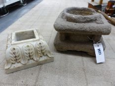 A CARVED STONE STAND OR MORTAR, COLUMNS AT EACH CORNER, THE TOP WITH CYLINDRICALLY RECESSED HOLLOW,