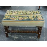 AN OAK STOOL, TAPESTRY SEAT OF FLOWERS AND OF GRAPES, BOBBIN TURNED. W 66 x D 41 x H 37cms.