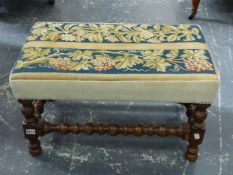 AN OAK STOOL, TAPESTRY SEAT OF FLOWERS AND OF GRAPES, BOBBIN TURNED. W 66 x D 41 x H 37cms.