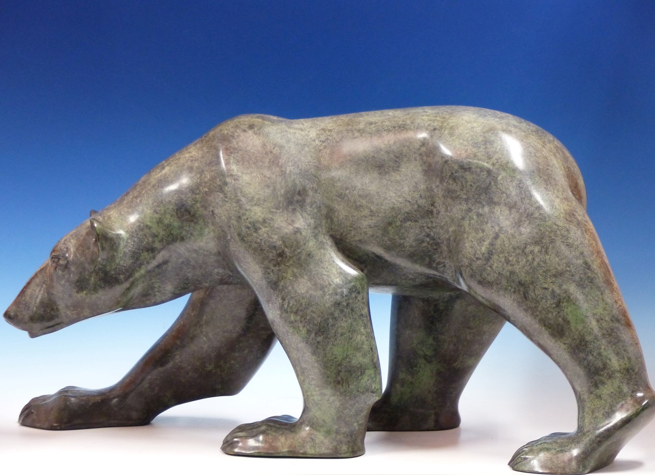 JONATHAN KNIGHT (1959-) ARR. PATINATED BRONZE OF A POLAR BEAR WALKING. SIGNED AND MONOGRAMED,