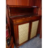 A REGENCY ROSEWOOD SIDE CABINET, THE RECTANGULAR TOP WITH REAR RECESSED SHELF, THE DAMASK INSET