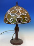 A TIFFANY STYLE TABLE LAMP WITH METAL BASE AND LEADED GLASS SHADE. H 47cms.