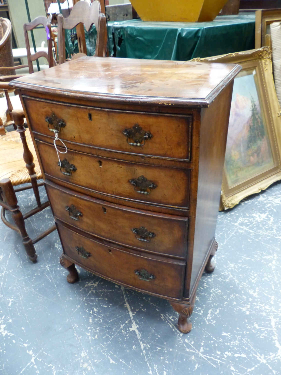 A SMALL GEORGIAN STYLE BOW FRONT FOUR DRAWER CHEST ON SHORT CABRIOLE LEGS. W.52 x D.35 x H.77cms.