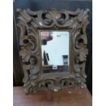 ANTIQUE CARVED GILTWOOD ITALIAN BAROQUE STYLE FRAME INSET WITH LATER MIRROR. H. 62 x W. 50cms.