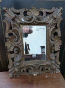 ANTIQUE CARVED GILTWOOD ITALIAN BAROQUE STYLE FRAME INSET WITH LATER MIRROR. H. 62 x W. 50cms.