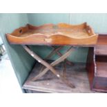 A MAHOGANY BUTLER'S TRAY WITH SHAPED GALLERY SIDES, ON A FOLDING STAND. 76 x 45cms.