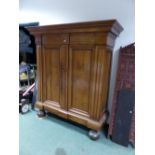 AN EARLY CONTINENTAL WALNUT BAROQUE STYLE ARMOIRE OF HEAVY CONSTRUCTION WITH MOULDED CORNICE, TWIN