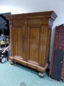 AN EARLY CONTINENTAL WALNUT BAROQUE STYLE ARMOIRE OF HEAVY CONSTRUCTION WITH MOULDED CORNICE, TWIN