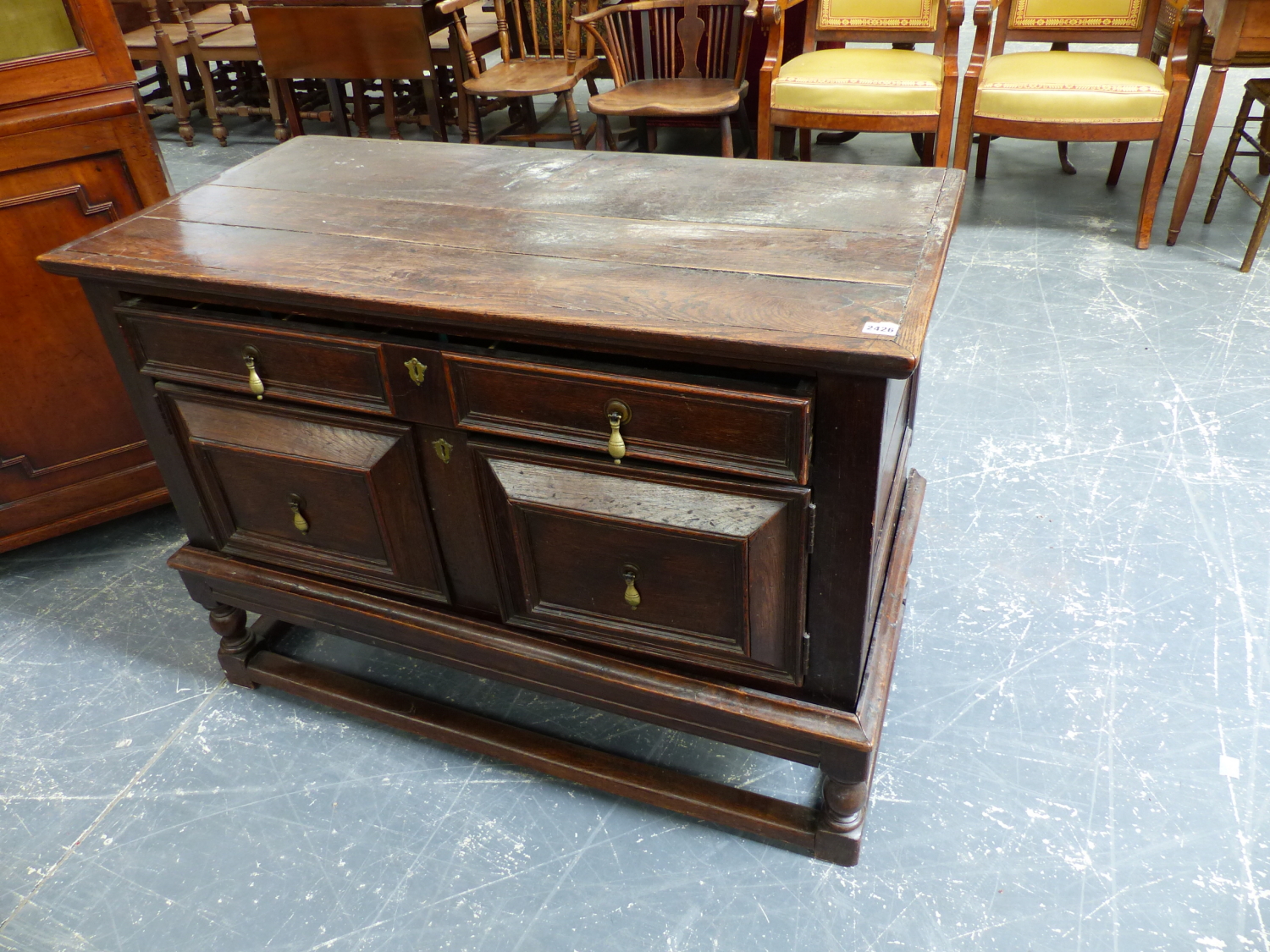 AN 18th.C.AND LATER OAK CABINET ON STAND WITH LONG FRIEZE DRAWER OVER TWO CUPBOARDS AND STRETCHER