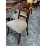 A SET OF SIX GEO.III.MAHOGANY AND BRASS STRUNG DINING CHAIRS WITH SABRE FORELEGS. (6)