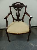 A CARVED MAHOGANY EDWARDIAN NEOCLASSICAL STYLE OPEN ARMCHAIR, REEDED TAPERED LEGS.