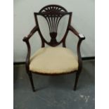 A CARVED MAHOGANY EDWARDIAN NEOCLASSICAL STYLE OPEN ARMCHAIR, REEDED TAPERED LEGS.