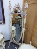 A FRENCH STYLE CREAM PAINTED OVAL CHEVAL MIRROR ENHANCED BY PINK AND CREAM ROSES WITH GREEN