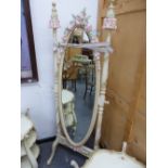 A FRENCH STYLE CREAM PAINTED OVAL CHEVAL MIRROR ENHANCED BY PINK AND CREAM ROSES WITH GREEN