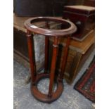 A 19th C. MAHOGANY STICK STAND, THE RING TOP SUPPORTED ON FOUR COLUMNS FLARING TO THE CIRCULAR