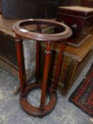 A 19th C. MAHOGANY STICK STAND, THE RING TOP SUPPORTED ON FOUR COLUMNS FLARING TO THE CIRCULAR