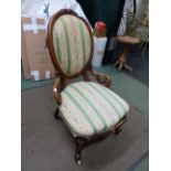 A VICTORIAN CARVED WALNUT OVAL BACK LADIES CHAIR, CERAMIC CASTERS.