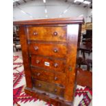 A COLLECTOR'S CABINET OF FIVE WALNUT FRONTED DRAWERS LOCKING BY A HINGED PILASTER TO THE RIGHT