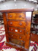 A COLLECTOR'S CABINET OF FIVE WALNUT FRONTED DRAWERS LOCKING BY A HINGED PILASTER TO THE RIGHT