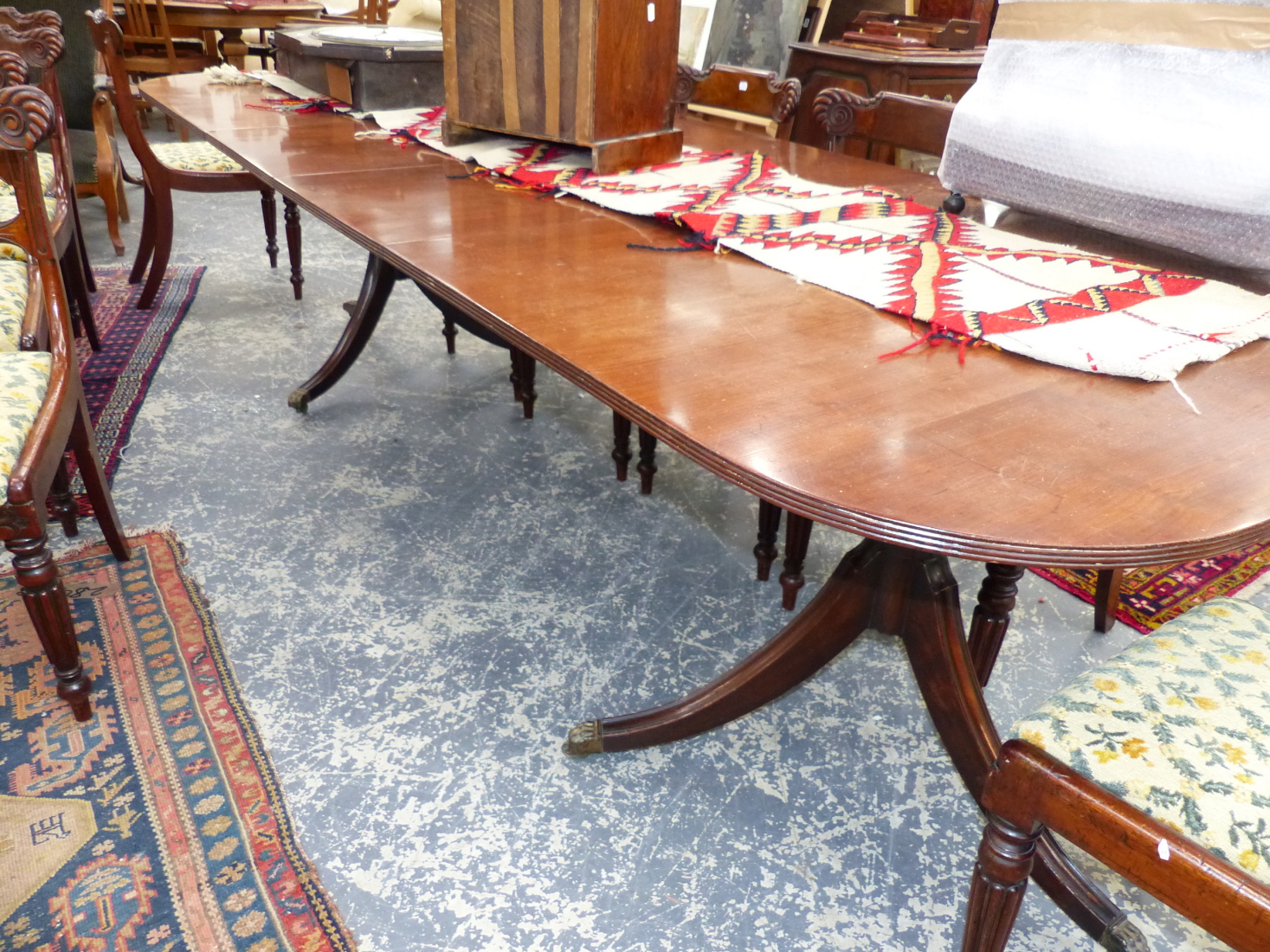 A GOOD ANTIQUE AND LATER MAHOGANY TWIN PEDESTAL DINING TABLE COMPLETE WITH ADDITIONAL LEAF. L.228
