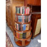 A 19th.C. MAHOGANY REVOLVING BOOK CASE WITH SOME BOOKS, EACH OF THE FIVE GRADUATED CIRCULAR TIERS